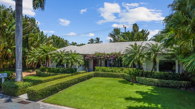 The front yard is landscaped with manicured hedges and palms. The house at 265 List Road in Palm Beach is listed for sale at $10.95 million.