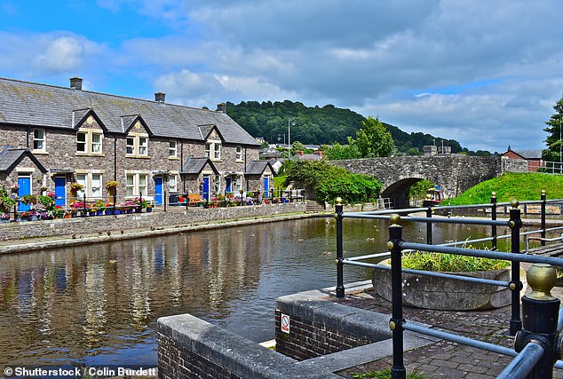 A terraced row of quaint cottages sit alongside a canal near Brecon, in Powys
