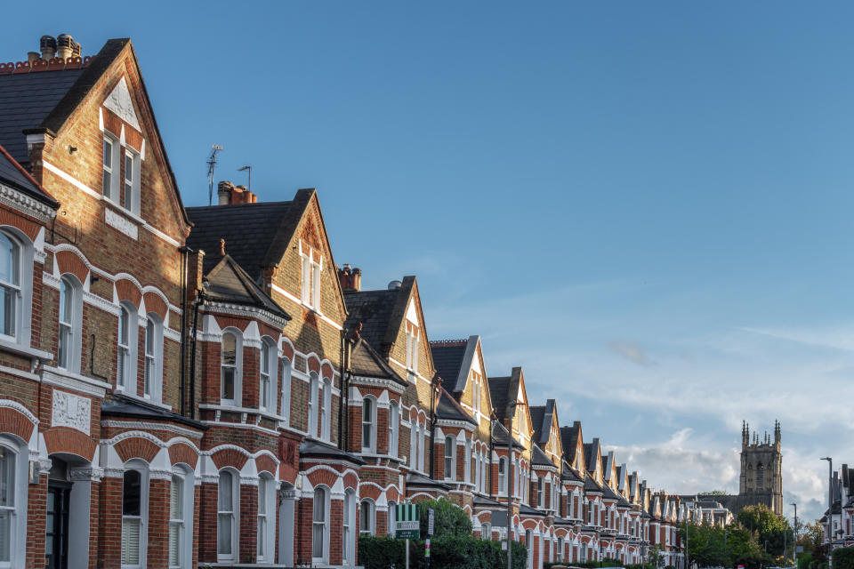 rent Clapham, London, Lavender Gardens SW11, a row of large brick terrace houses, Victorian style 19th Century architecture,  copy space with clear blue sky, church tower in the distance, no people