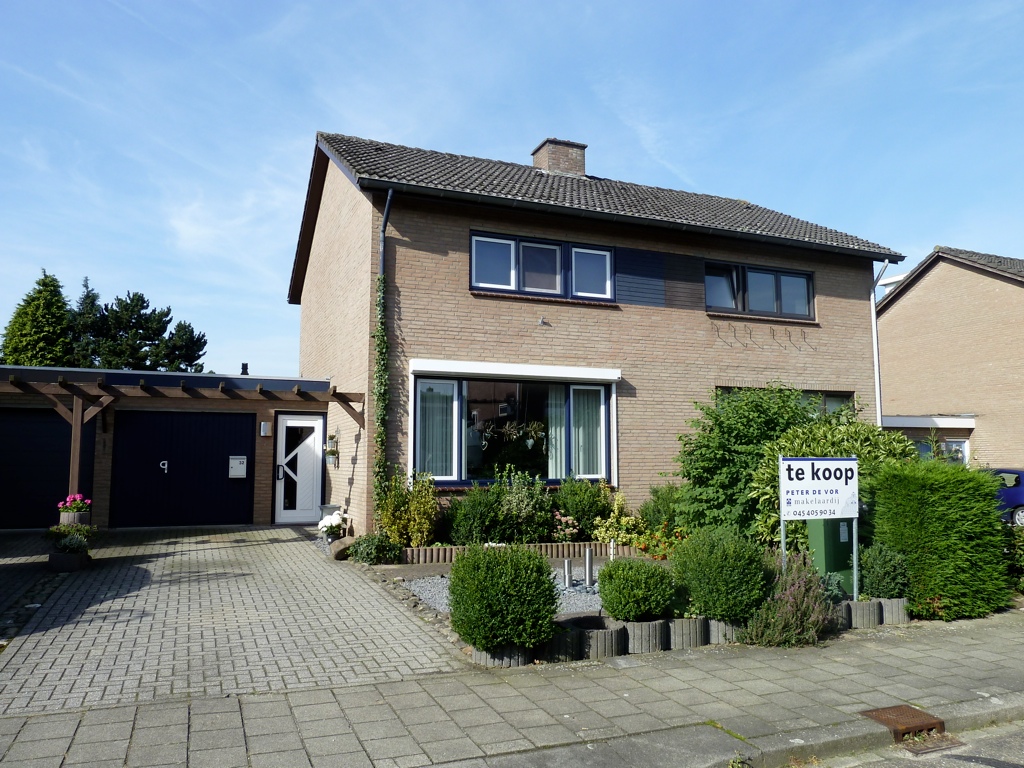 Detached Dutch house with For Sale sign.
