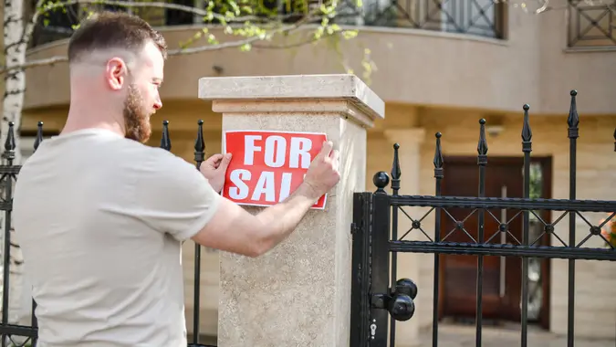 Bearded Male Declaring House For Sale stock photo