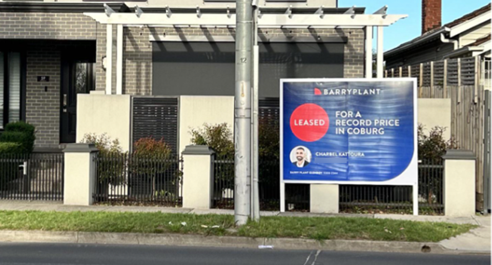 A picture of real estate agent Charbel Kattoura is on the sign which reads 'Leased for a record price in Coburg'.