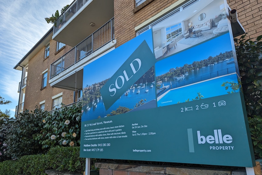 A sold sticker on a for sale sign for a two-bedroom apartment in the Sydney habourside suburb of Mosman.