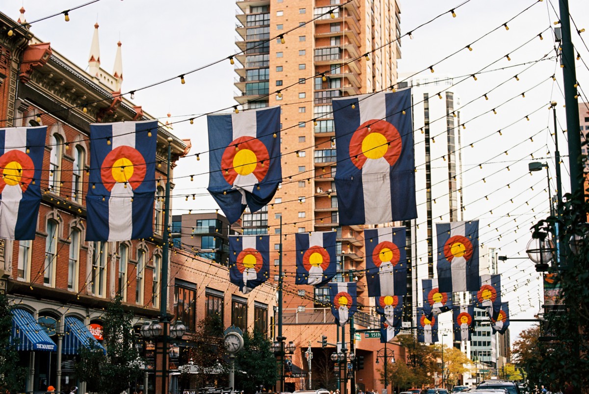 downtown denver street with lots of colorado flags