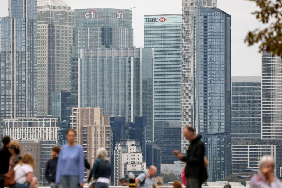 FILE PHOTO: People stand at Greenwich Park, with the Canary Wharf financial district in the distance, in London, Britain, August 29, 2023. REUTERS/Kevin Coombs/File Photo