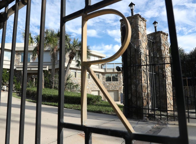 An "R" can be seen on the gate entrance to the oceanfront mansion of the late Hawaiian Tropic founder Ron Rice at 175 Ocean Shore Blvd. in Ormond Beach on Monday, Nov. 28, 2022 in Ormond Beach.