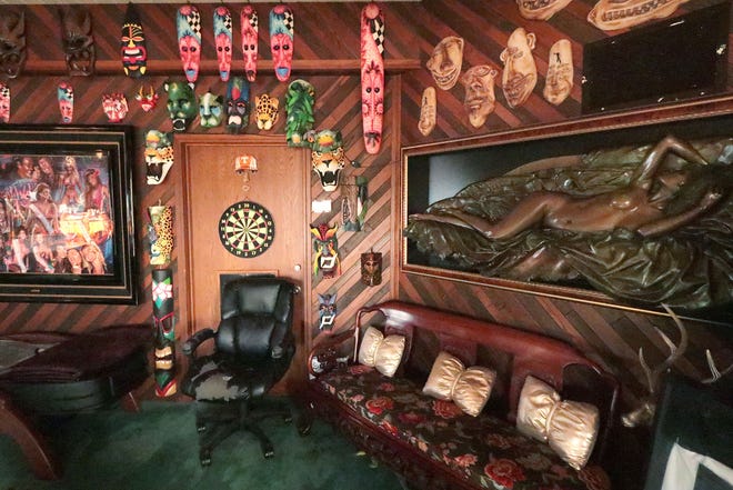 Artwork and a dart board adorn the walls inside the dining room in the oceanfront mansion of the late Hawaiian Tropic founder Ron Rice on Monday, Nov. 28, 2022. Rice's estate put the luxury home at 175 Ocean Shore Blvd. in Ormond Beach up for sale on Thanksgiving Day 2022.