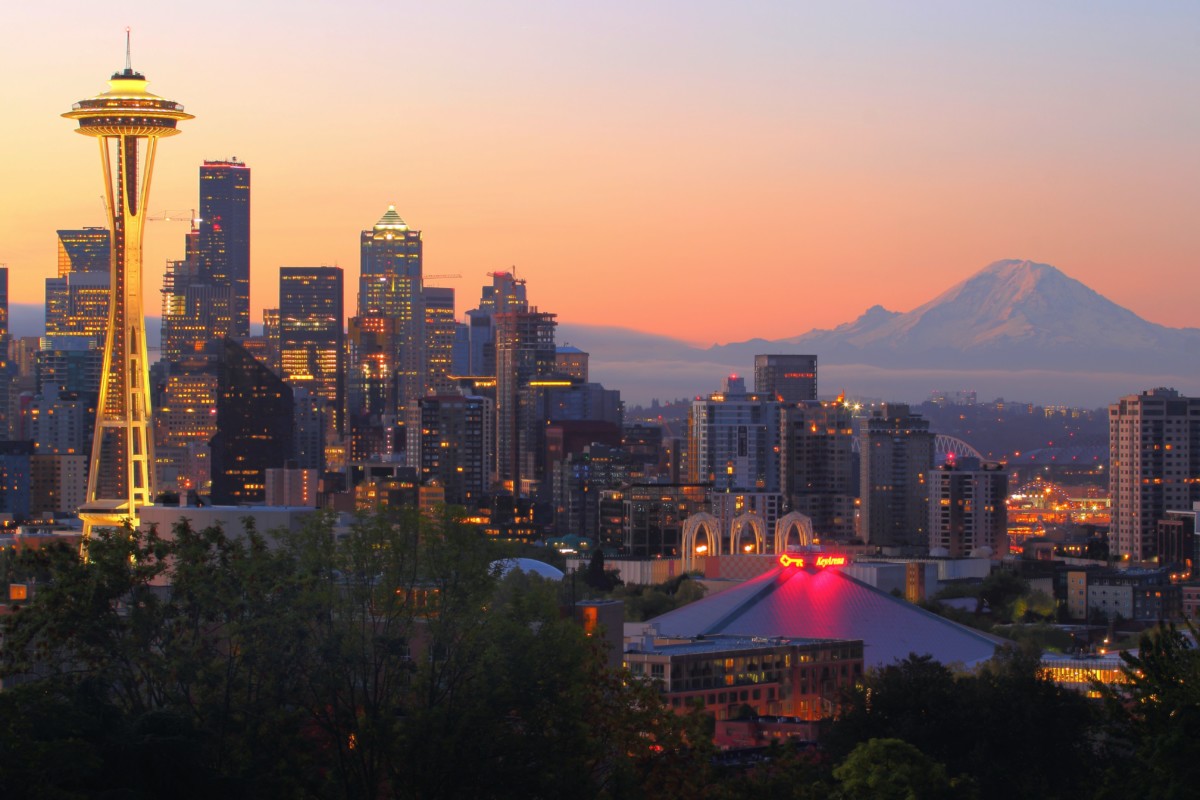 seattle skyline at sunset with the space needle and mount rainier