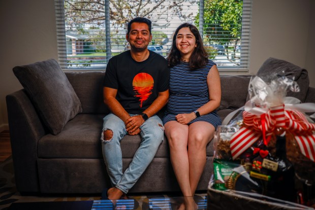 Husband and wife Nishant Sigh, left, and Apeqsha Dudani, right, sit in their new home in San Jose, Calif., on Friday, April 5, 2024. They are expecting their first child in July. (Shae Hammond/Bay Area News Group)