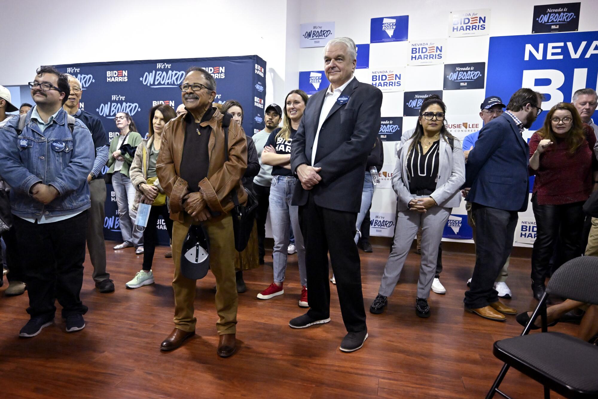 Former Nevada Gov. Steve Sisolak, center, at a newly opened Democratic campaign office in Las Vegas.
