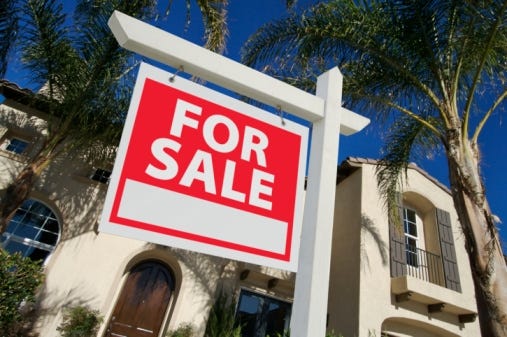Sold Home For Sale Sign in Front of New House (Thinkstock photo)